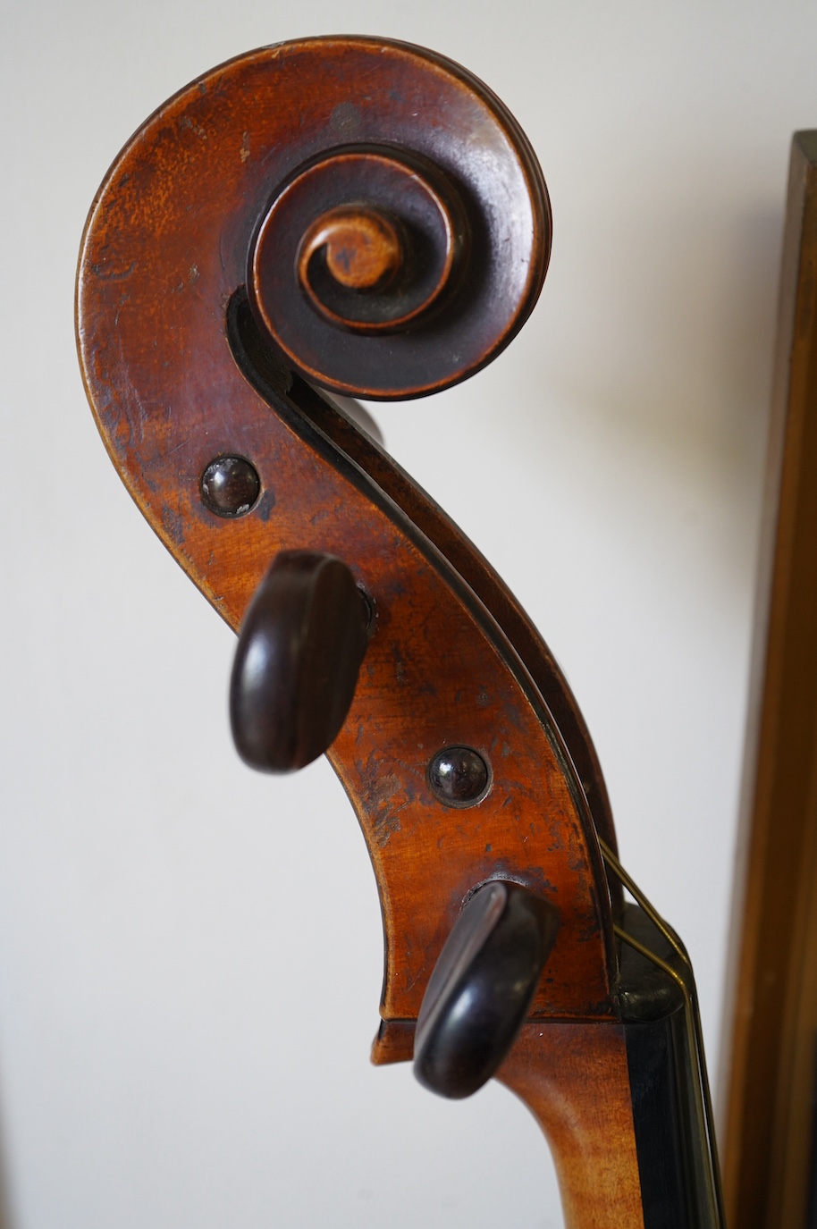 An early 19th century cello with a Stradivarius label, body 76cm, with a P&H bow, in a good modern case. Condition - poor